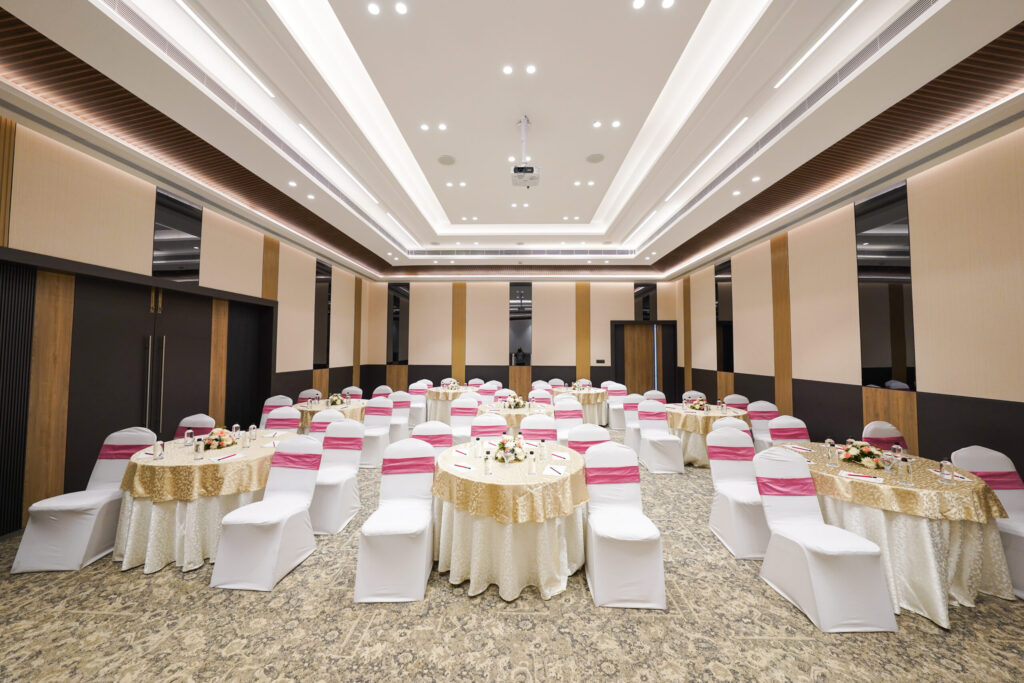 Ivory Hall at The Woodrose Club, JP Nagar, set with round tables